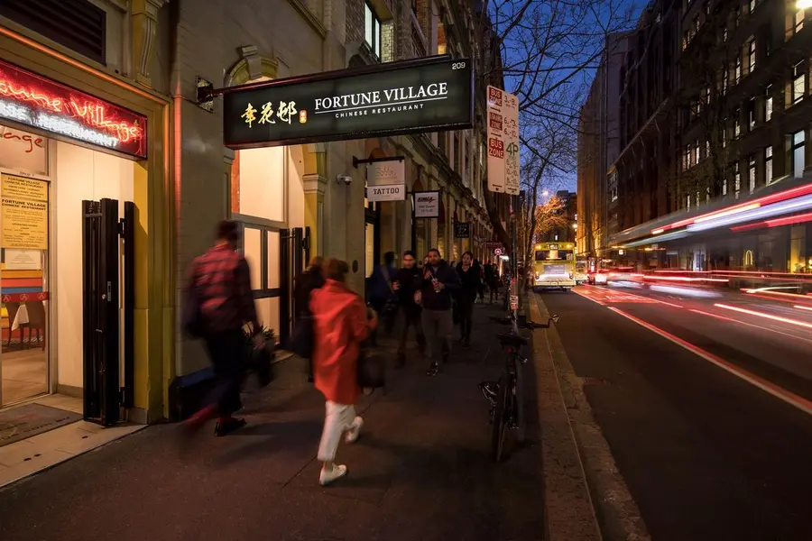 Fortune Village’s sign glowing on Clarence Street at night